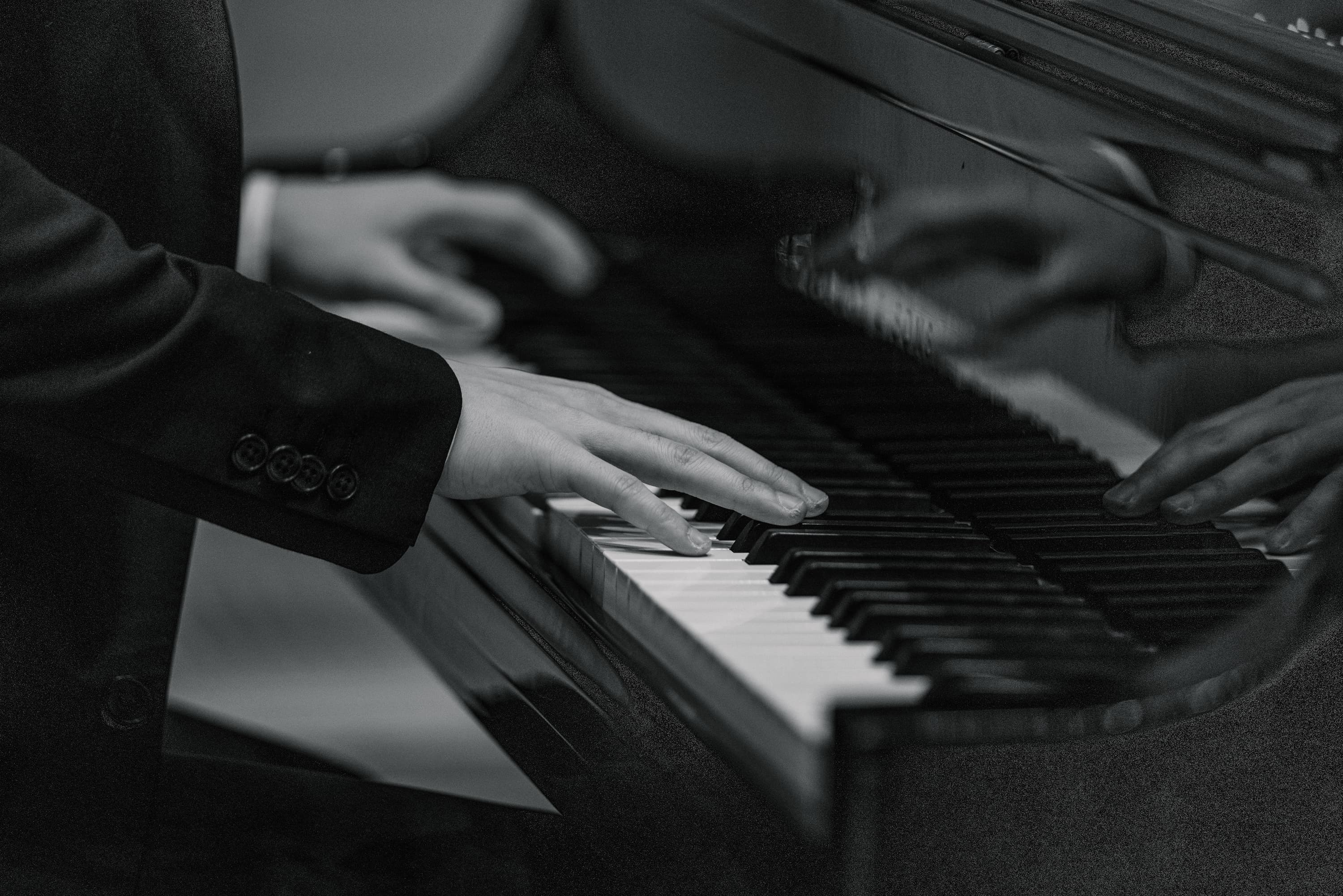 Adult pianist with small hands playing a narrow keyboard without injury