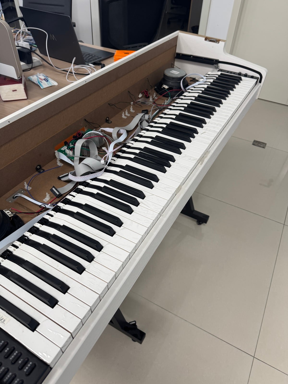 Inside the prototype: keybed, speaker and wiring on the bench